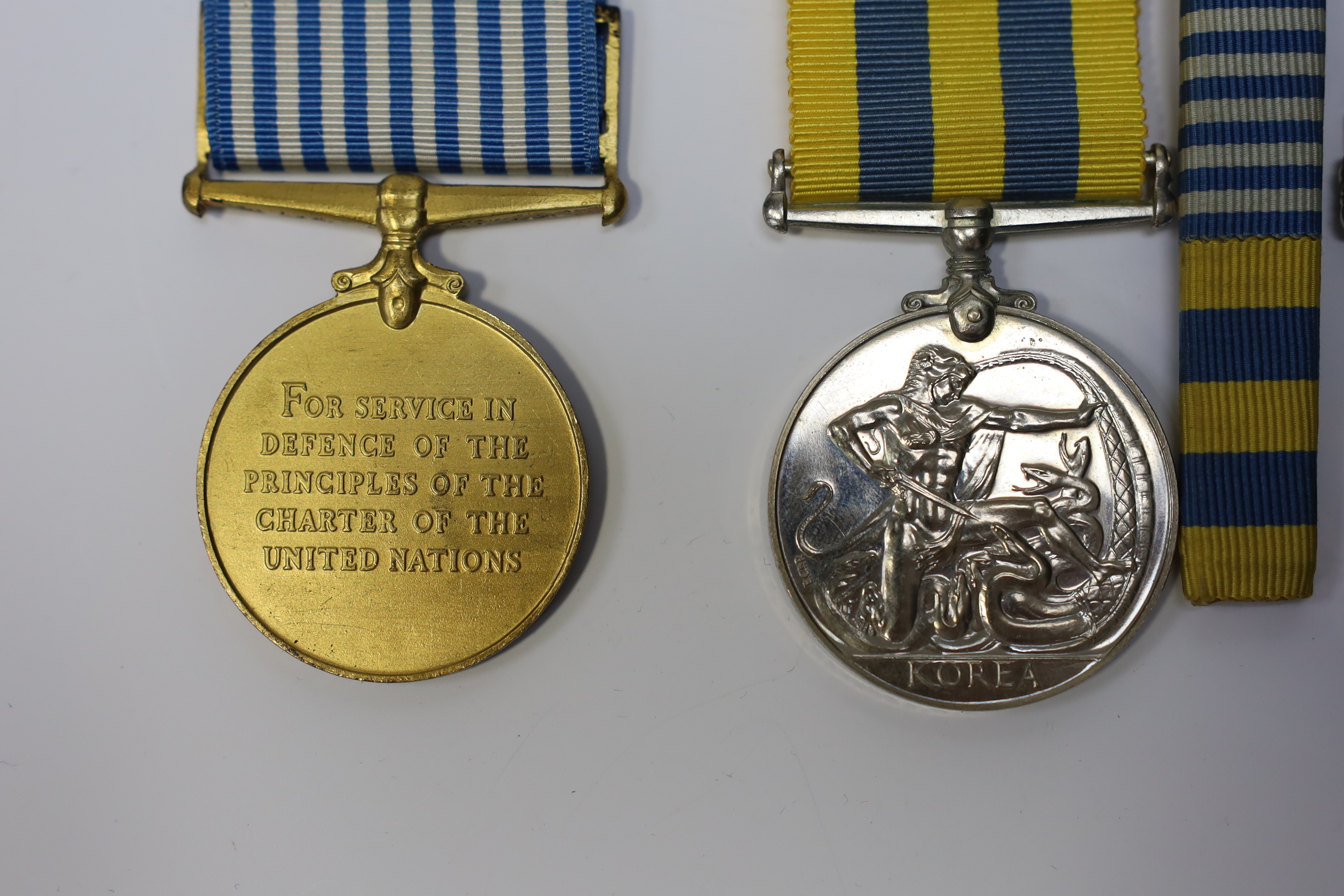 An ERII Operational Service Medal for Afghanistan awarded to Sgt. A.J. Pugsley RAMC (R), together with a Korea medal pair awarded to Sigmn. A.G. Lickman R.Sigs., all in separate issue boxes. Condition - fair to good